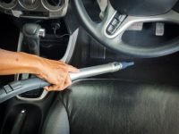 Man Holding Vacuum Handle Cleaning Inside Cabin Car. Electronic Equipment For Dust Clean.